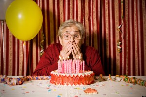 Astonished old grandmother lost her dentures while she try to blowing out the candles on the cake for her birthday. Image shot 2008. Exact date unknown.